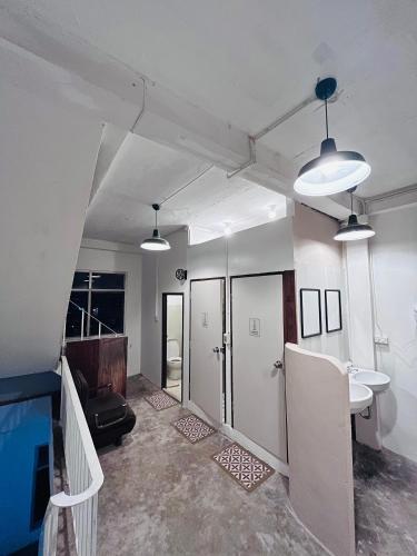 an empty room with a staircase and two lights at Zanit Hostel in Don Muang Airport