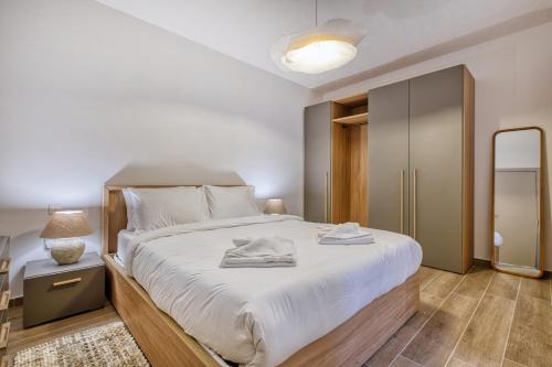 a bedroom with a large bed with towels on it at Seafront 3 Bedroom Luxury Getaway in St. Paul's Bay