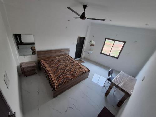 an overhead view of a bedroom with a bed and a table at VnM Paradise in Chunār
