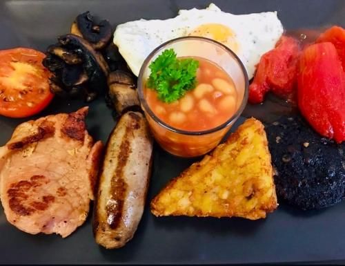 a plate of breakfast food with eggs and vegetables at The Annexe, St Andrews house hotel, Two bedrooms Sleeps 4 in Preston