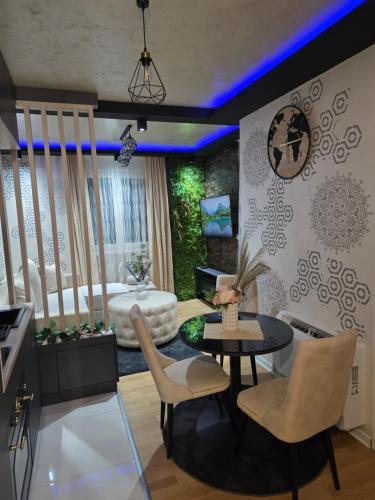 a living room with a table and chairs at POSEJDON DELUXe 4 in Vrnjačka Banja
