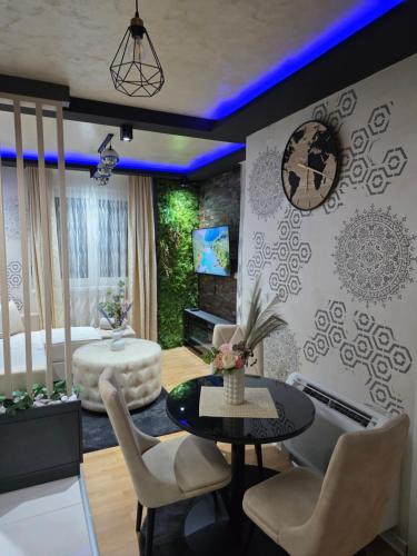 a living room with a table and chairs at POSEJDON DELUXe 4 in Vrnjačka Banja