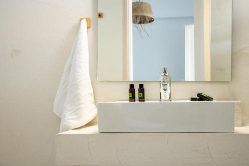 a bathroom with a white sink and a mirror at Nuevo Vista in Kavos
