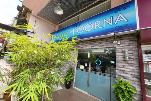 a pomona store with a sign on the front of it at Poorna Hotel at Jalan Ipoh Sentul Kuala Lumpur in Kuala Lumpur