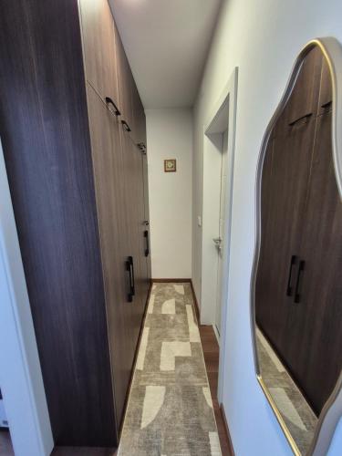 a hallway with two stalls and a mirror at Avram in Vrnjci