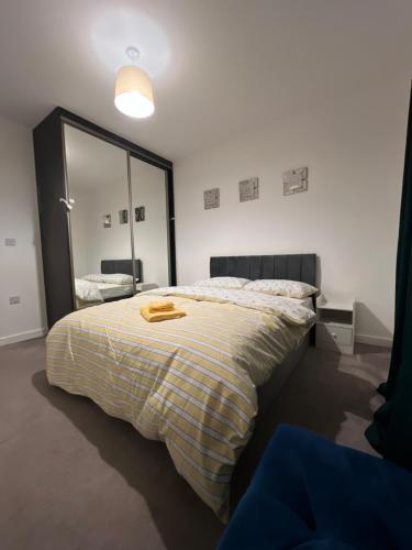 a bedroom with a bed and a large mirror at Modern 3 Bedroom House in Hornchurch in Hornchurch