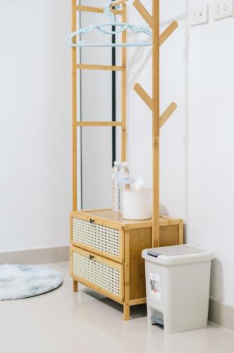 a bathroom with a wooden cabinet and a mirror at 11 House - 9 mins drive to LeeGarden,parking available in Ban Kohong