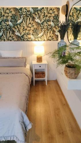 a bedroom with a bed and a table with a lamp at Las i Woda in Lubin