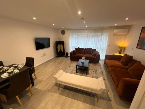 a living room with a couch and a table at Modern 3 Bedroom House in Hornchurch in Hornchurch