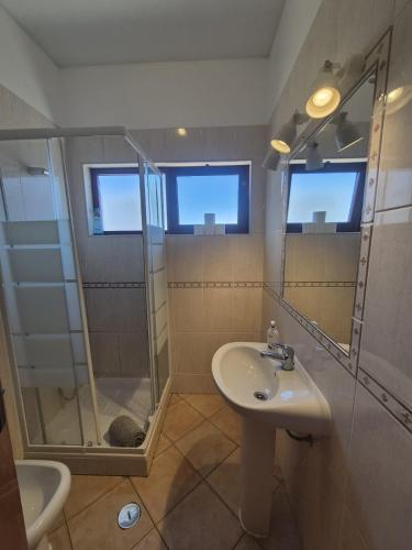 a bathroom with a shower and a sink at Casa da Baixa in Faro