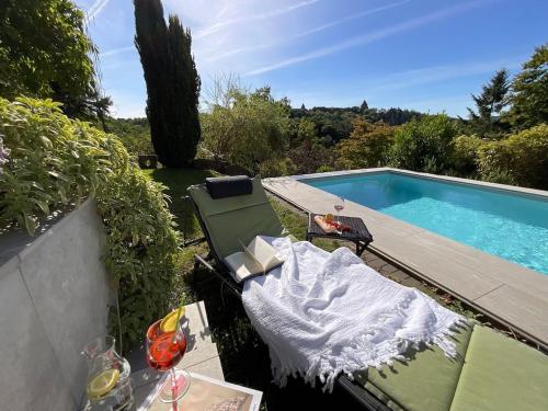 a swimming pool with a table and a bench next to it at Schiller Ferienwohnung, Pool, Nideggen, Eifel in Nideggen