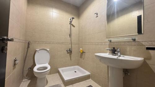 a bathroom with a toilet and a sink at Spacious 2BR Apartment,3 Bathrooms, Near Mall in Abu Dhabi