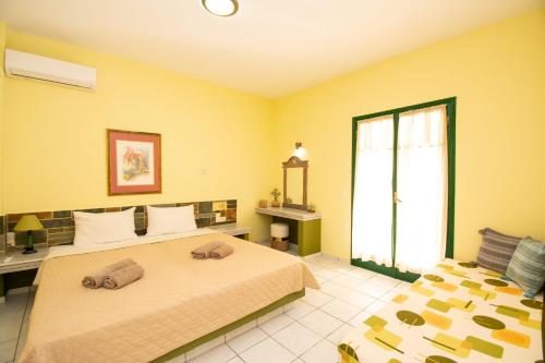 a bedroom with two beds and a window at Aquarius Apartments "by Checkin" in Agia Pelagia