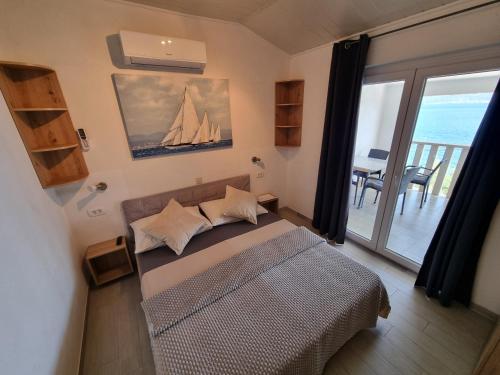 a bedroom with a bed with a view of the ocean at Villa Ana in Slatine