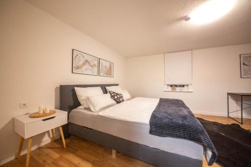 a bedroom with a large bed and a white cabinet at Mimi's Home in Dußlingen