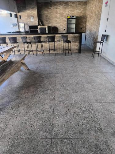 an empty room with chairs and a bar in a building at Espaço de eventos dorneles in Senador Canedo