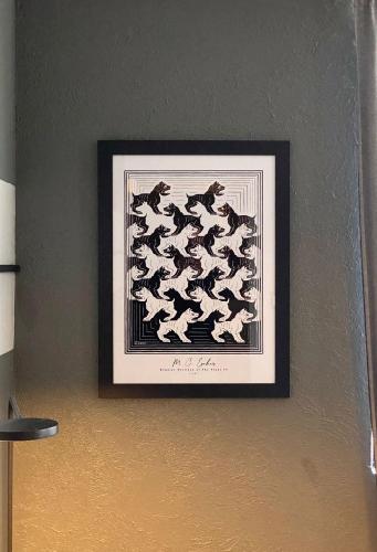 a framed picture of dogs on a wall at Bright Studio Apartment Casa Icacos Apt 3 in Mexico City