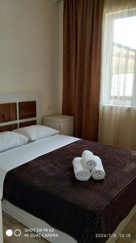 a bedroom with a bed with towels on it at Gogasar house in Ijevan