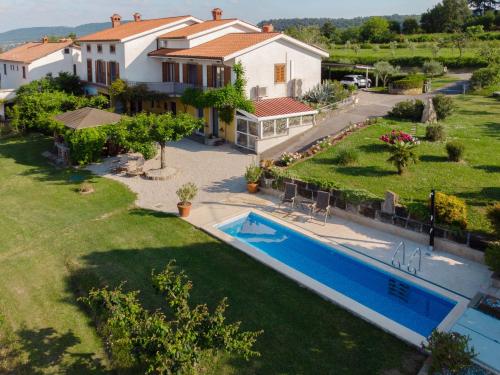 an aerial view of a house with a swimming pool at Med oljkami Apartment in Koper