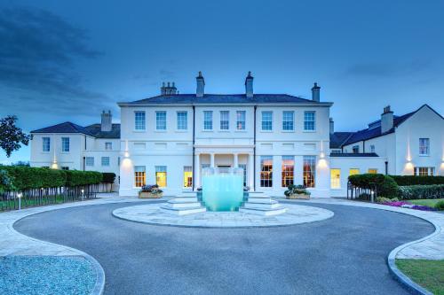 a large white house with a fountain in the middle at Seaham Hall and Serenity Spa in Seaham