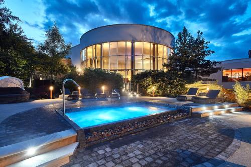 a large building with a swimming pool in front of it at Seaham Hall and Serenity Spa in Seaham