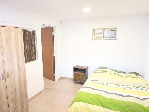 a bedroom with a bed and a dresser in it at Old City Charm in Beer Sheva