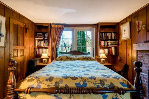 a bedroom with a bed and a window and bookshelves at Highland Ave in Norwalk