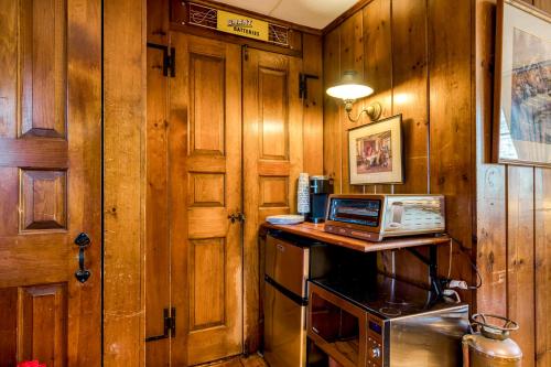 a kitchen with wooden walls and a laptop on a counter at Highland Ave in Norwalk