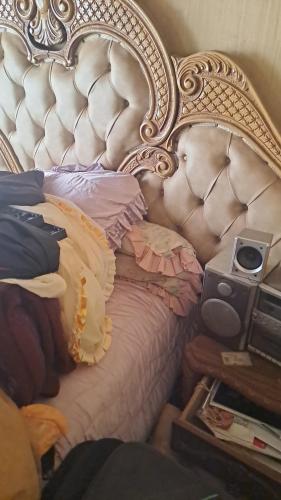 a bedroom with a bed with an ornate headboard at Tetelos house in Cullinan