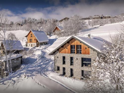 a house in the snow with snow covered trees at Chalet Confidentiel - OVO Network in Doucy