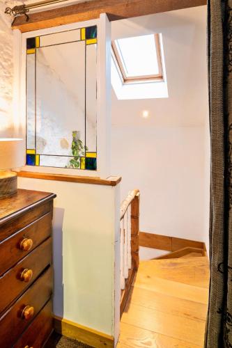 a room with a skylight and a dresser at Finest Retreats - Little Roost in Lyme Regis