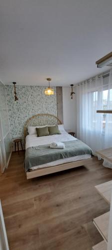 a bedroom with a large bed in a room at EBEIA Casas Rurales IBEAS DE JUARROS (BURGOS) in Ibeas de Juarros