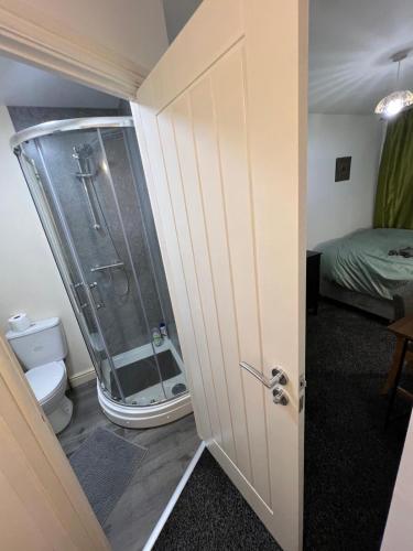 a bathroom with a shower and a toilet at Spacious Double Room Close to Derby City Centre in Derby