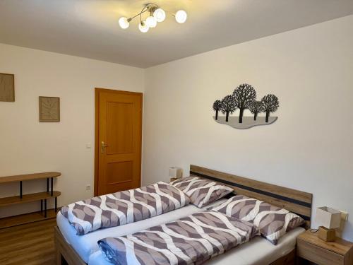 a bedroom with a bed with trees on the wall at Ferienhaus am Bauernhof mit Terrasse nähe Wexl Arena in Sankt Corona am Wechsel
