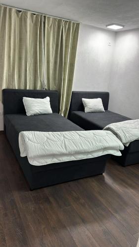 a bedroom with two beds and a window at APARTMANI Sarajevo in SJJ
