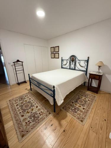 a bedroom with a bed and a wooden floor at Casa Clara in Castelo de Vide