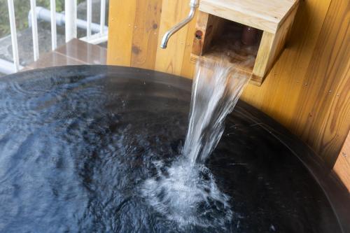 a plunge pool with water coming out of a water fountain at Shirahama White Beach House - Self Check-In Only in Shirahama