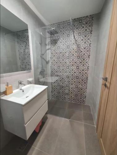 a bathroom with a sink and a shower at Master Quart studio apartment in Podgorica