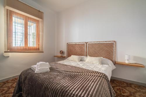 a bedroom with a bed with two pillows on it at Les Villetes in Moncófar