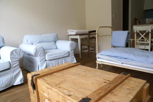 a living room with a couch and a table at Domaine Pyrénées Passions - Gîtes de Charmes & Caractère in Estadens