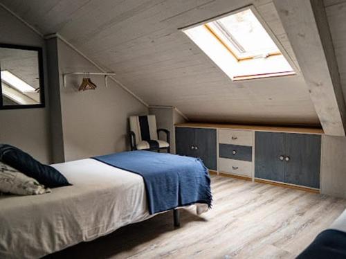 a bedroom with a bed and a skylight at Casa de Tintas in Cuenca