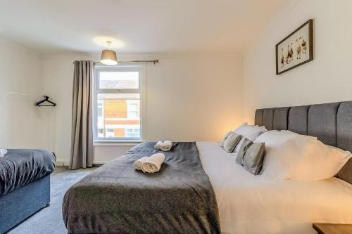 a bedroom with a large bed and a window at Barnwell by Holmesdale Homes in Kettering