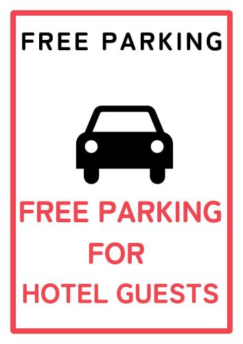 a sign that reads free parking for hotel guests at ブルーリバー1991 in Fukuoka