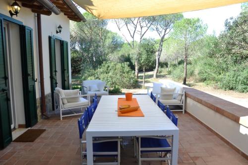 a white table and chairs on a patio at Tenuta le marze in Castiglione della Pescaia