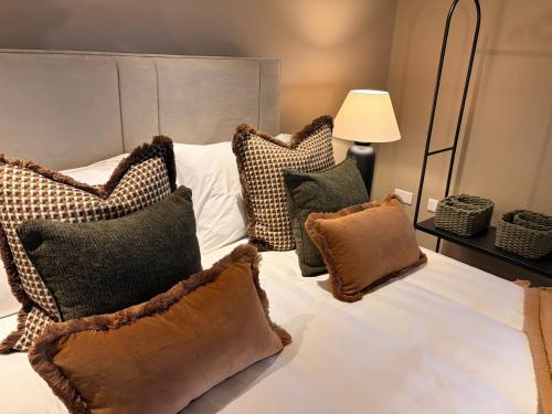a bedroom with a bed with pillows on it at Heath Hideaway in Sowerby Bridge