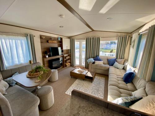 a living room with a couch and a table at The Waterfront in South Cerney