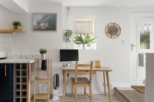 a kitchen with a desk with a computer on it at Beautiful Apartment with Parking Central Exeter in Dean