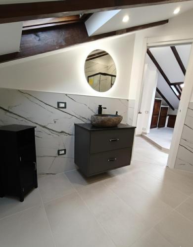 a bathroom with a sink and a mirror on the wall at Villa Buby in Pettenasco
