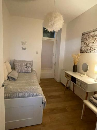 a bedroom with a bed and a desk and a window at Dunoon River Clyde Flat in Innellan