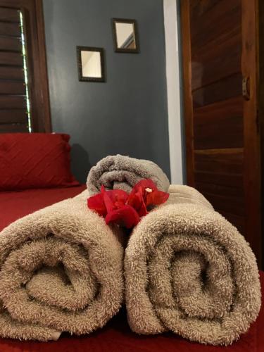 a pile of towels on top of a bed at Casa Praiana Moitas in Praia de Moitas
